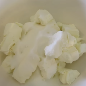 This image show the mixing of the softened Philadelphia Cream Cheese, sugar, flour, and vanilla extract until smooth and creamy