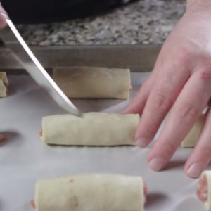 The image shows irish sausage rolls ready to bake