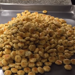 The image shows the coated oyster crackers ready to bake