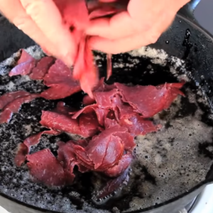 The image shows browning the beef for Shit on A Shingle Recipe