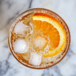 The image shows citrus shrub cocktail in a glass ready to serve