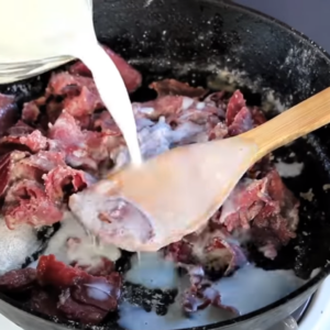 the images shows adding milk to the Shit on A Shingle Recipe