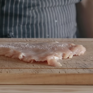 This image shows seasoning of chicken breasts with salt and pepper for chicken katsu recipe