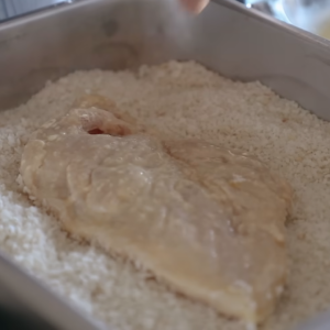 This image shows coating of chicken breasts with flour, beaten egg, and panko crumbs for chicken katsu recipe