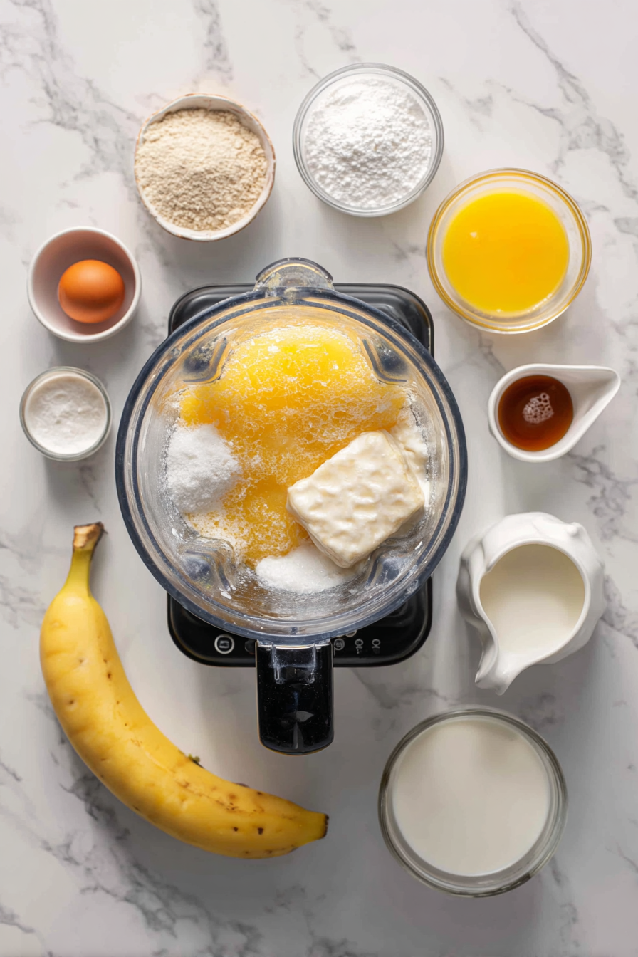 Crush ice cubes in a blender until snow-like.Add orange juice concentrate, milk, table cream, banana, sugar, egg, powdered creamer, and vanilla extract.