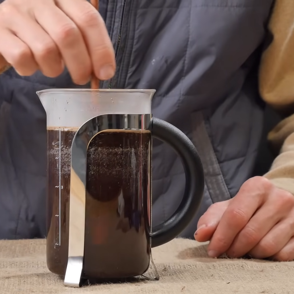 This image shows stirring the french press coffee in coffee maker
