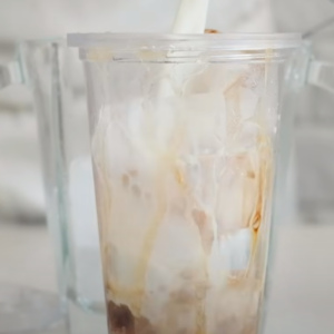 this image shows pouring the milk and coffee mixture
