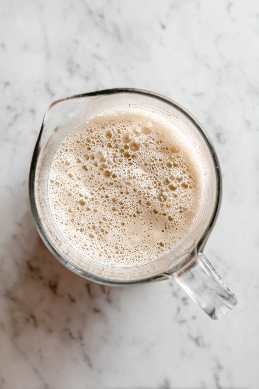 Combine yeast, sugar, and water in a glass measuring cup; let sit for 10 minutes.