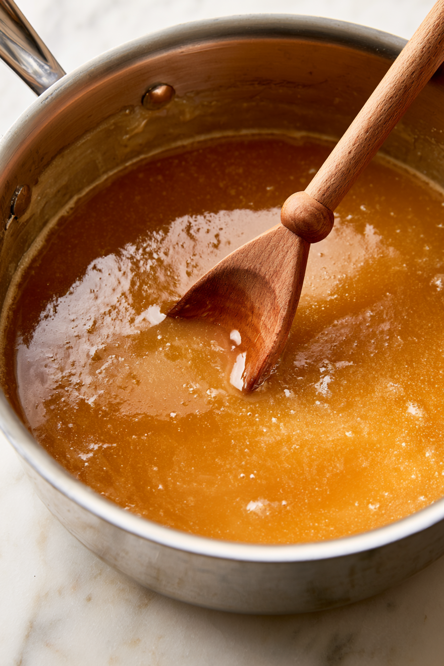 Add sugar, heavy cream, corn syrup, and butter to a heavy-bottomed saucepan