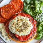 This image shows ground beef being mixed with Italian seasoning, pizza spices like oregano and garlic, creating a flavorful beef mixture in preparation for making pizza burgers.