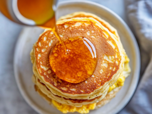 McGriddle sandwiches served on an elegant plate, showcasing the warm, golden-brown pancakes and melted cheese.