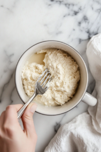 the image shows the process of mixing ingredients for brownie in a mug recipe