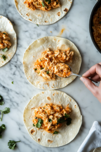 this image show putting the filling on Buffalo Chicken Taquitos