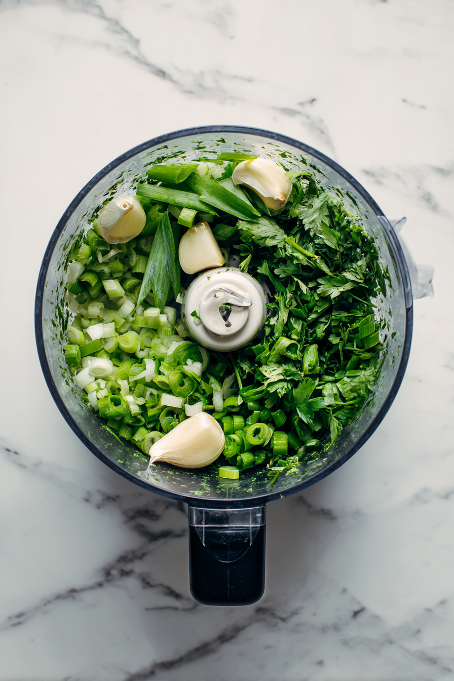 In a food processor, blend scallions, garlic, and cilantro until finely chopped.
