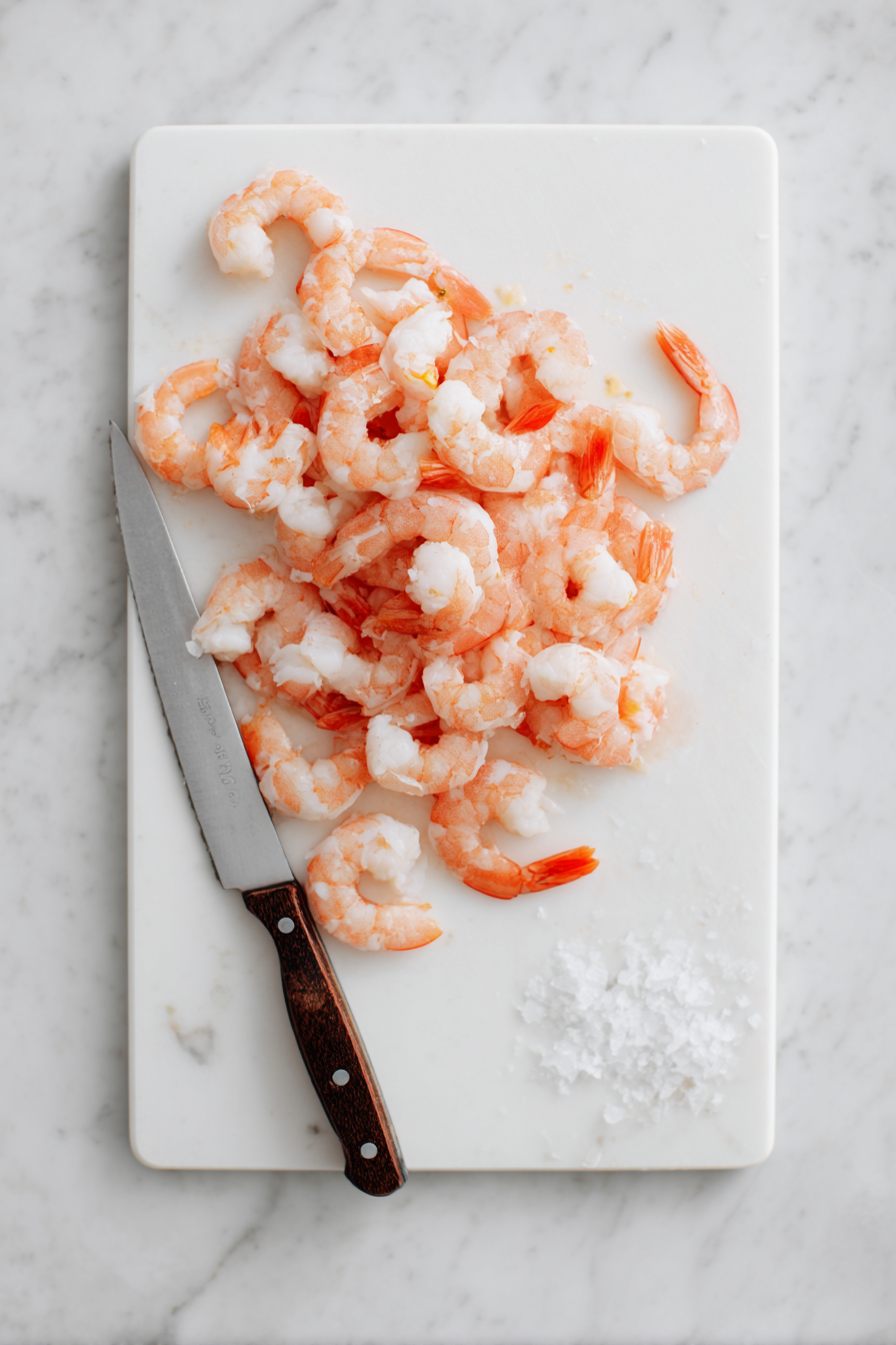 To butterfly shrimp, make a lengthwise incision across the middle of each one.