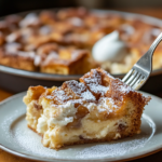 Serving the Strawberry Bread Pudding with Powdered Sugar and Whipped Cream