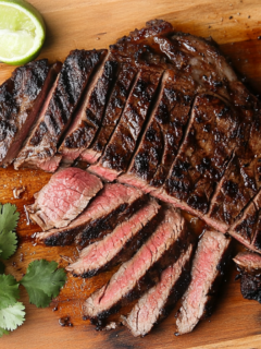 This image shows the juicy Ranchera Meat served on a plate, garnished with fresh herbs and sides, highlighting the delicious, savory, and citrusy flavors of the dish.