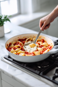 Arranging filled pasta shells in onion sauce