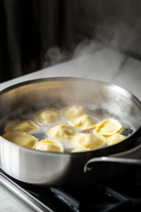 Boiling homemade pumpkin ravioli in salted water