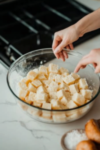 Coating bread cubes with pumpkin mixture