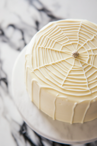 Creating Web Effect on Chocolate Spider Web Cake with Toothpick