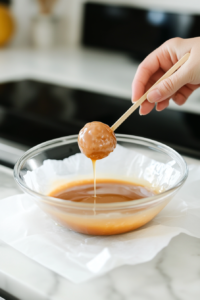 Dipping Mini Donuts in Melted Candy for Full Candy Coating