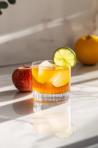 Garnishing Autumn Rickey cocktail with apple slice and lime wheel