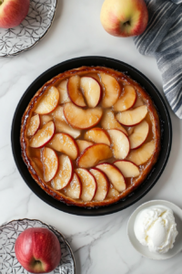 Golden pie crust baking over caramelized apples