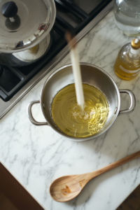 Heating vegetable oil for Dumpling Soup recipe in a large pot over medium heat