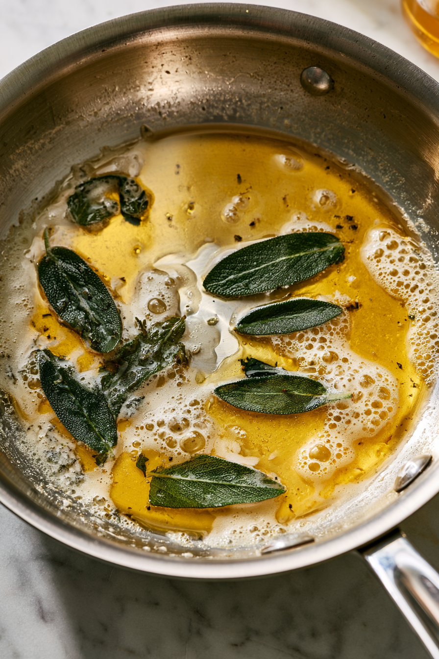 Melt butter in a pan with fresh sage leaves over medium heat, stirring until the butter browns slightly