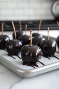 Placing Black Caramel Coated Apples on Baking Sheet