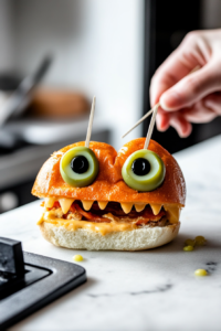 Placing Green Olives on Toothpicks for Monster Burger Eyes