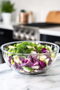 Mixing radicchio, brussels sprouts, and dill in a large bowl.