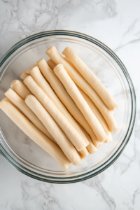 Rolling out crescent roll dough and pressing seams