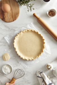 Rolling out pie dough for Tarte Tatin crust preparation