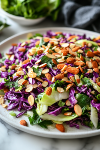 This image shows the finished chicken salad on a platter. It is topped with toasted almonds and ready to be enjoyed.