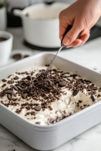 Topping with Oreo Crumbs and Chilling Graveyard Cake