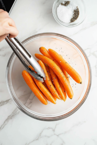 Tossing the Carrots with Olive Oil and Seasoning for Roasted Carrots