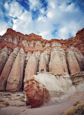 Scenic view of Red Rock Canyon State Park with stunning red rock formations, clear blue skies, and vast desert landscape, a popular spot for hiking and nature photography.

