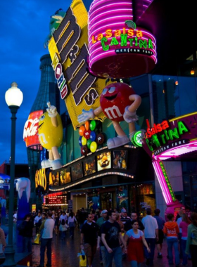 Bustling night scene of the Las Vegas Strip, showcasing iconic hotels, bright lights, and energetic street life, capturing the excitement of this popular entertainment destination.