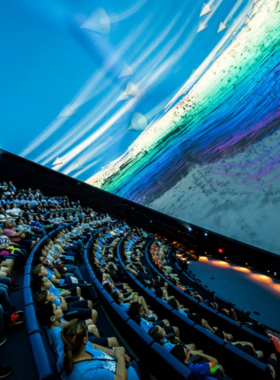  Image of the Frost Science Planetarium, featuring a modern architectural design surrounded by lush greenery, highlighting its role as a premier destination for science and astronomy education in Miami.