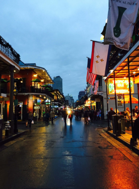  Street musicians performing on Frenchmen Street in New Orleans, surrounded by crowds enjoying the live music, capturing the vibrant cultural and musical energy of the area.

