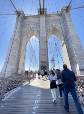 Iconic view of the Brooklyn Bridge, connecting Manhattan and Brooklyn, with panoramic views of the New York City skyline.