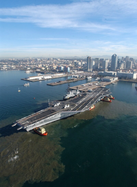 The USS Midway aircraft carrier, docked at Navy Pier in San Diego, now serving as a naval aviation museum. The image shows the massive decommissioned carrier that offers tours and exhibits on naval history. The USS Midway Museum is a popular San Diego attraction for history enthusiasts.