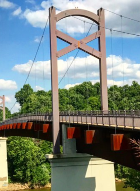 Pedestrian bridge in Nashville, offering a panoramic view of the river and city skyline.