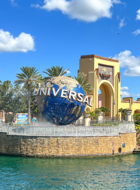 The grand entrance of Universal Studios Orlando, marked by an iconic archway and colorful banners, welcoming guests into a world of cinematic adventure and themed attractions.