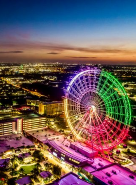 The ICON Park Observation Wheel in Orlando, a towering Ferris wheel with colorful lighting, offering panoramic views of the city and a popular attraction for both locals and tourists.

