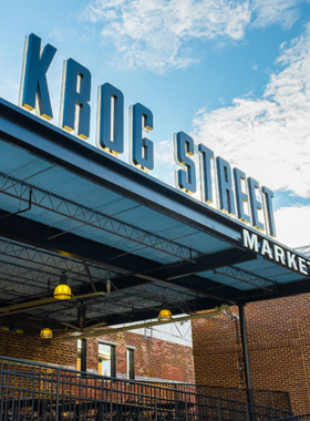 The bustling interior of Krog Street Market in Atlanta, with modern industrial decor and an array of local food vendors and artisan shops, showcasing a vibrant marketplace atmosphere.