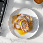 Serving the finished Pumpkin French Toast warm with syrup, powdered sugar, or cinnamon-sugar for a delicious breakfast or brunch.