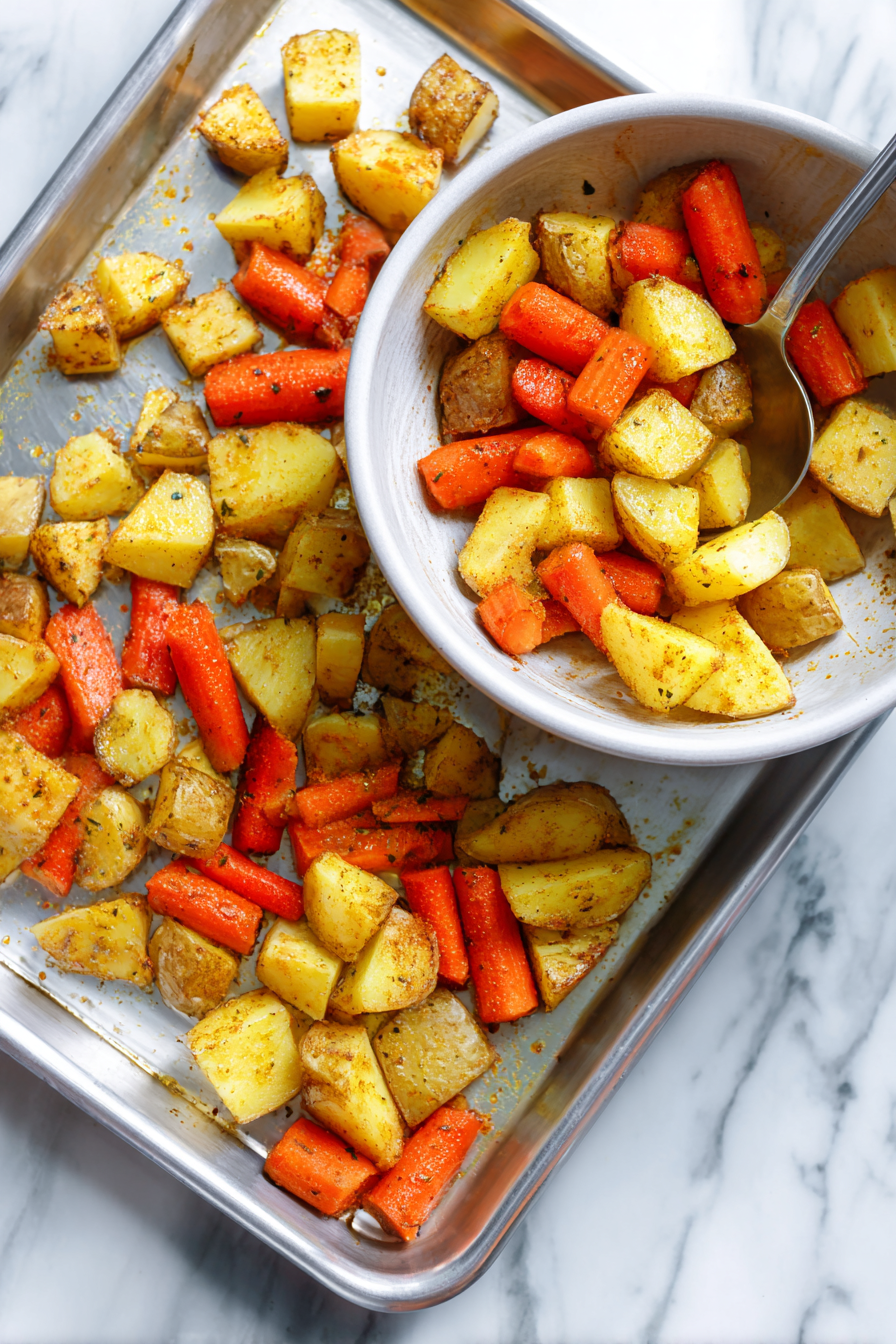 Spread the potatoes and carrots onto a rimmed baking sheet.